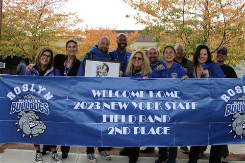 admins in front of banner 